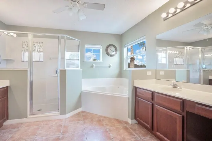 The Primary SPA-INSPIRED EN SUITE BATH includes dual vanities, a garden tub, a step-in shower, and a private water closet.