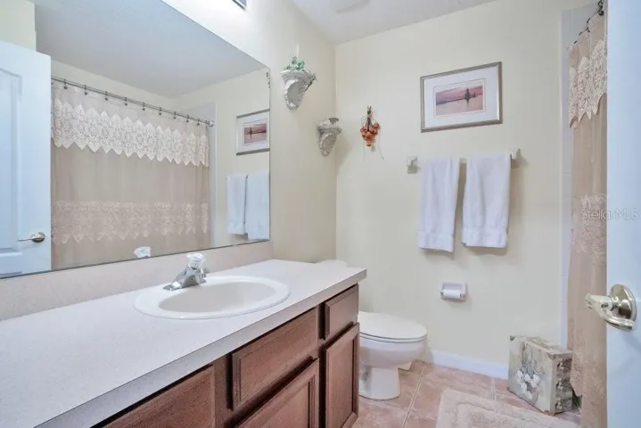 Two additional bedrooms share a THIRD FULL BATH.