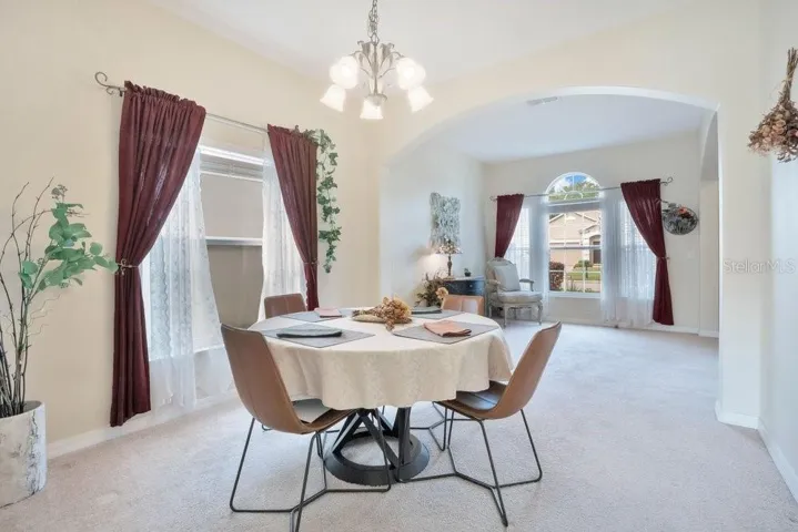 The LIGHT-FILLED Living Room provides a comfortable place to gather, flowing effortlessly into the elegant Dining Room, where large windows invite in NATURAL LIGHT.