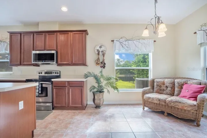 The spacious Kitchen is designed for both everyday living and entertaining, featuring stainless steel appliances, a CENTER ISLAND, breakfast bar, closet pantry, and abundant cabinetry and counter space, along with a SUNLIT BREAKFAST NOOK perfect for casual mornings.
