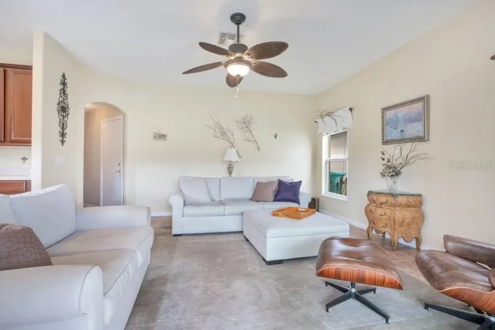 Overlooking it all, the Family Room is both open and inviting, complete with ceramic tile flooring and NEW IMPACT, ENERGY-EFFICIENT SLIDING GLASS DOORS that lead to the outdoor living space.