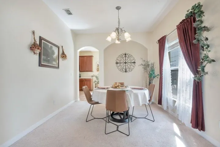 The LIGHT-FILLED Living Room provides a comfortable place to gather, flowing effortlessly into the elegant Dining Room, where large windows invite in NATURAL LIGHT.