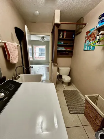 laundry with utility sink and toilet