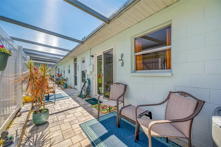 Relaxed screened lanai behind the home
