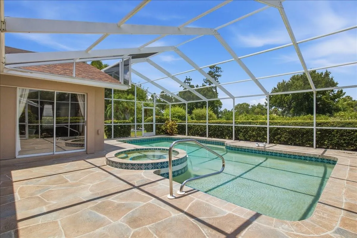 Large pool deck with pool and spa on North side of home