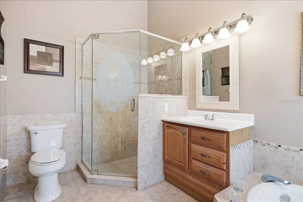 Separate sinks with garden tub between, and separate shower