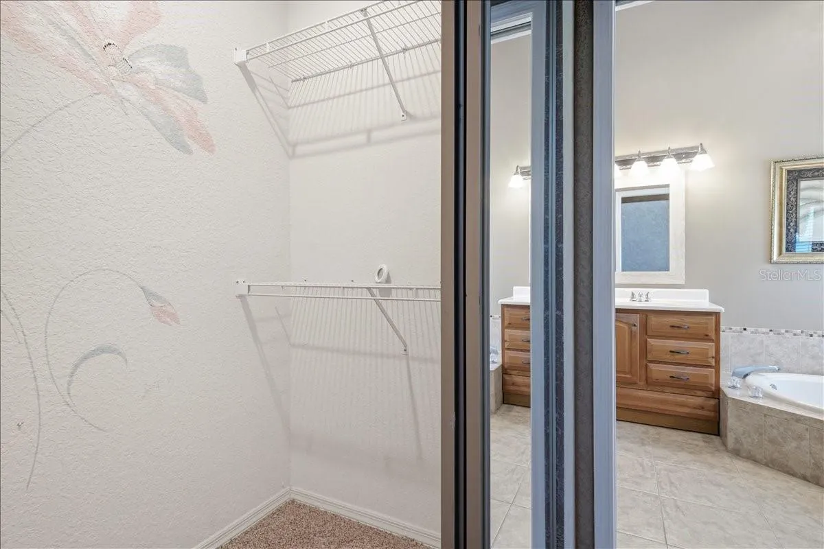 Two large walk-in closets in hall into ensuite bath