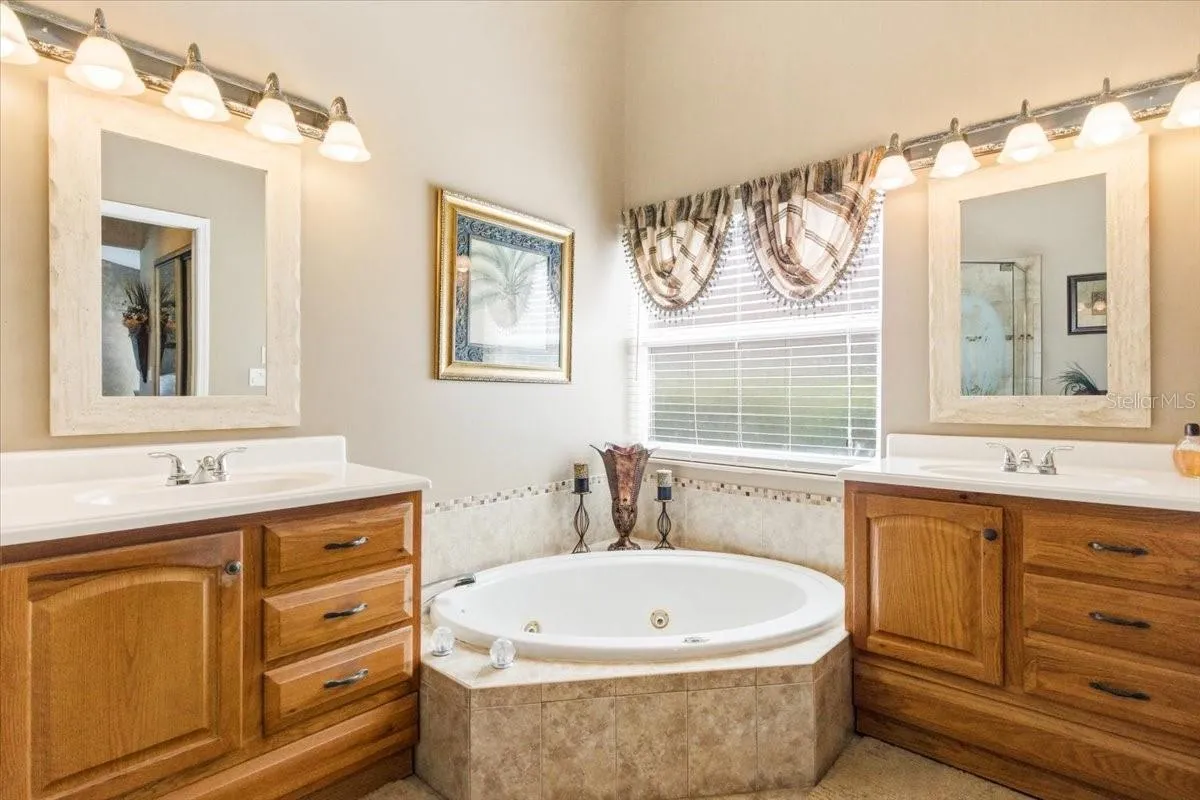 Primary bath features whirlpool garden tub and split vanities