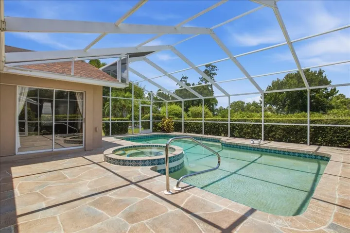 Large pool deck with pool and spa on North side of home