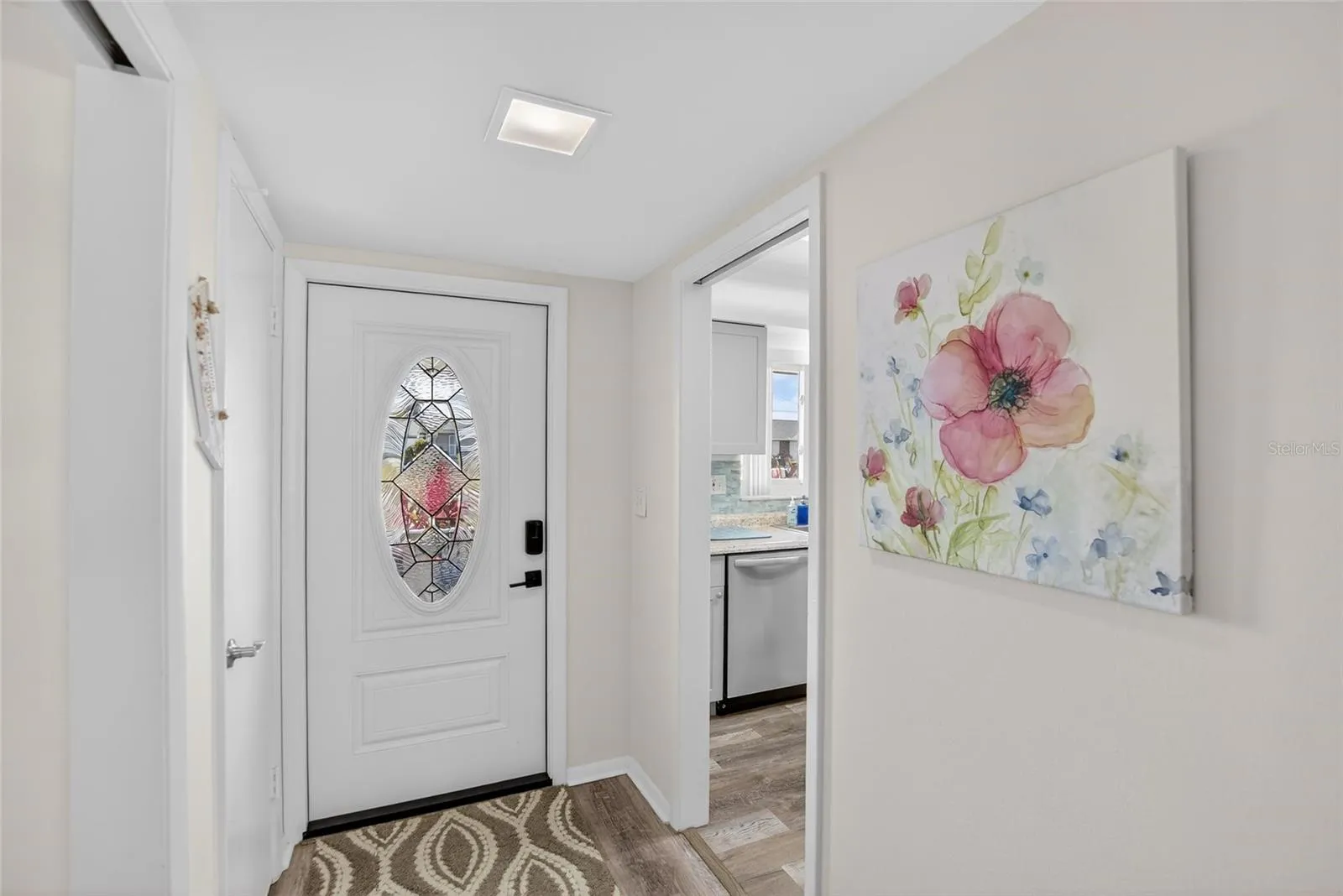 Walking in the lead glass door with keyless entry, notice the beautiful continuous floor