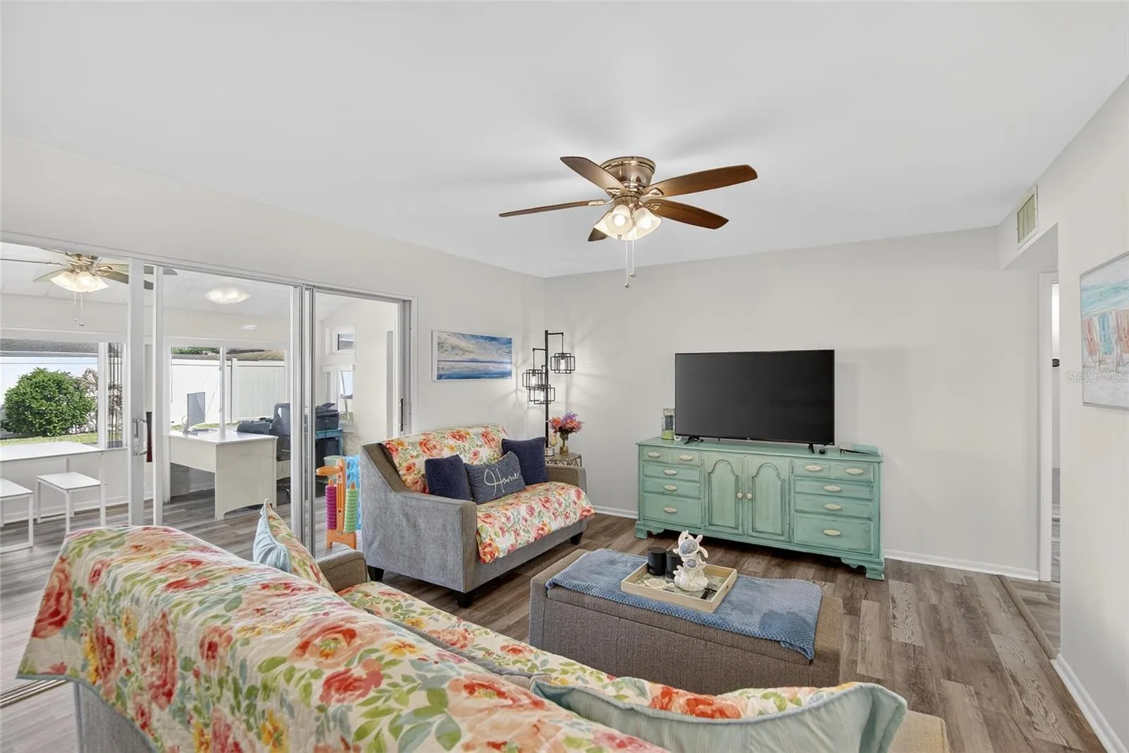 Modern paint tones, clean floors and space make this a perfect family room