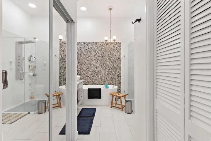 Mirrored closet door adds pizazz to this bathroom...
