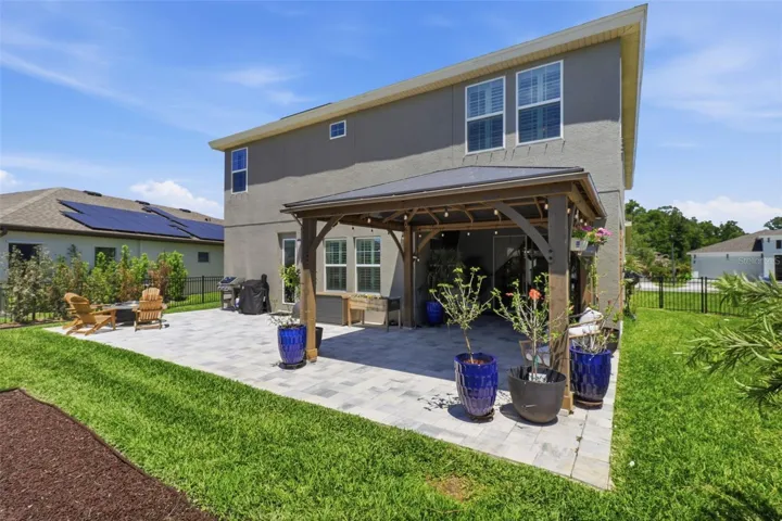Outdoor paved seating area with a gazebo overlooking the playground—perfect for relaxing or entertaining.