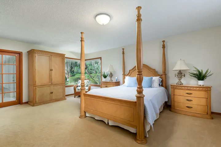 Spacious primary suite with French doors.
