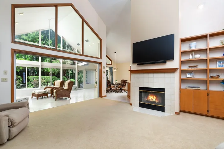 Bright family room with wood burning fireplace.