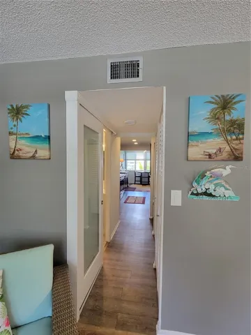 Hallway from living/dining area to rear of unit overlooking courtyard