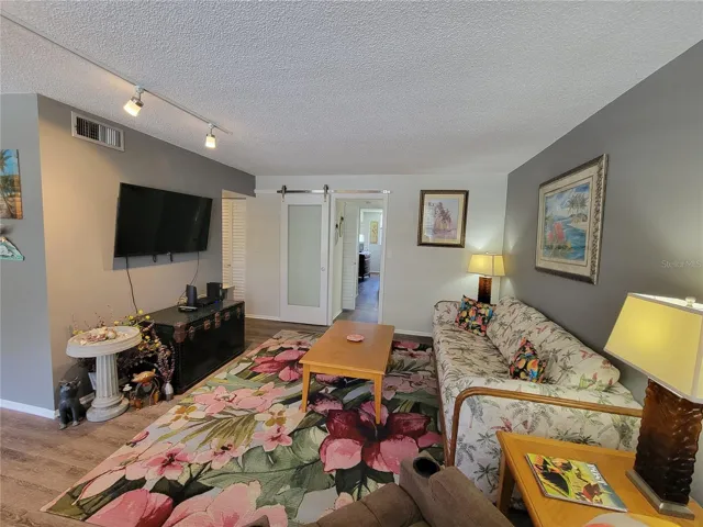 Living Room with master bedroom access in background