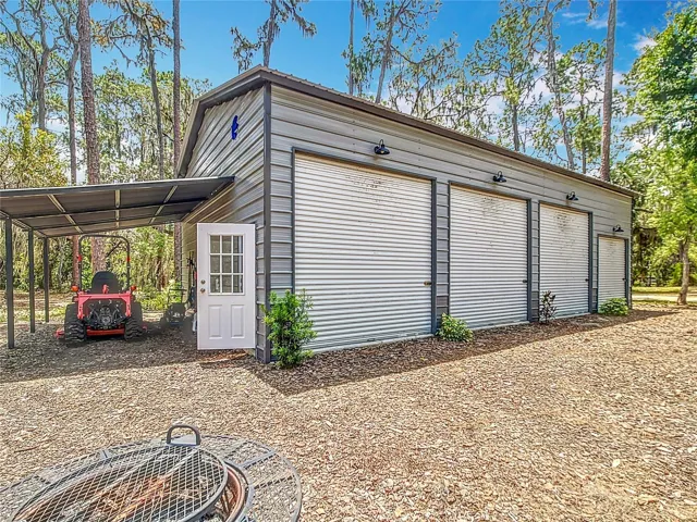 Four bay detached metal workshop with electric and lean to