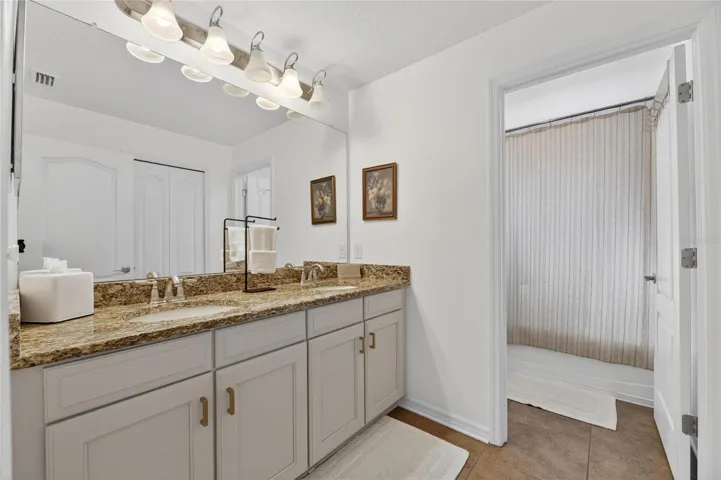 Upstairs bath has two sinks, tub and shower.