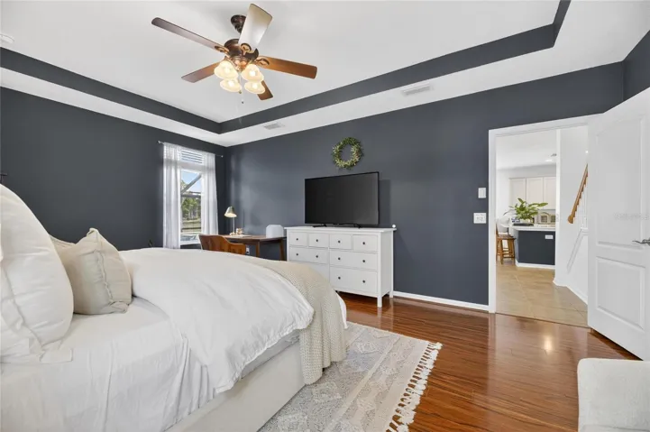 Primary bedroom has an overhead fan