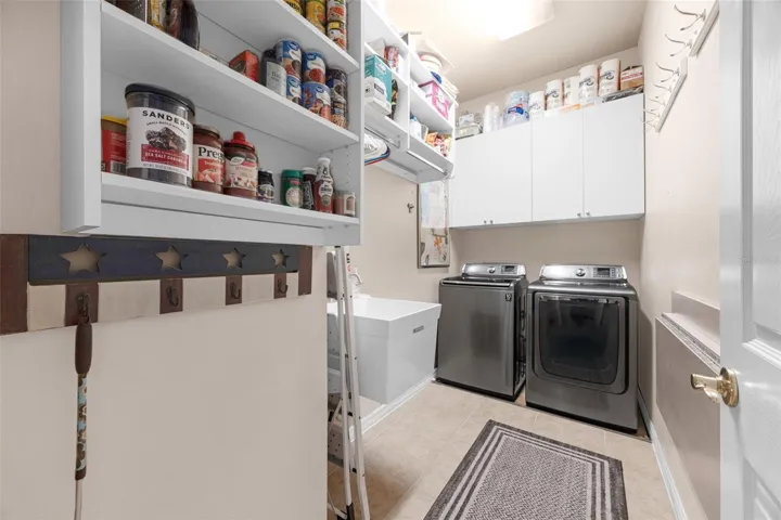 The Laundry Room has a utility sink, overhead cabinets, and lots of storage space.