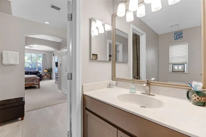 Private water closet features a second vanity and sink.