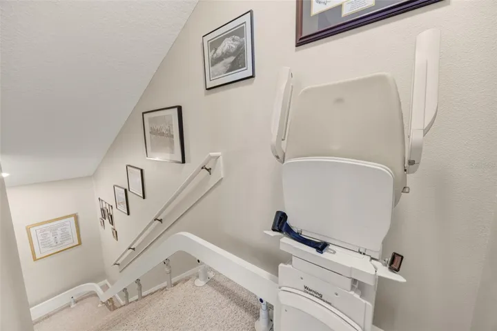 A chair lift is attached to the stairs (not the wall), and can easily be removed if desired.