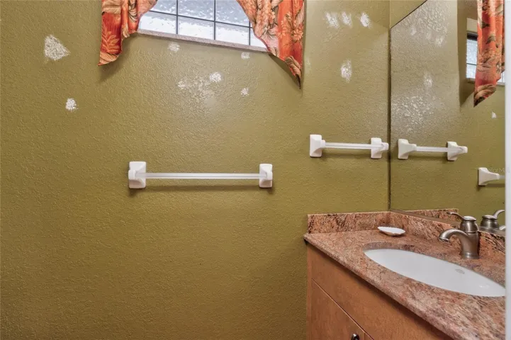 Half bath off the pool - Sorry, seller didn't have time to touch up the areas on the wall where pictures were removed!