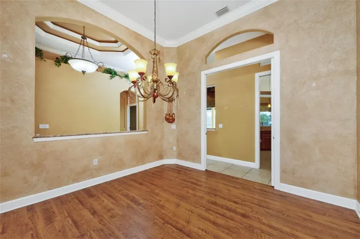 Formal dining room - note the crown moulding and ceiling treatment in the foyer