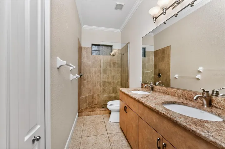 Guest bath also has a vanity with dual basins.