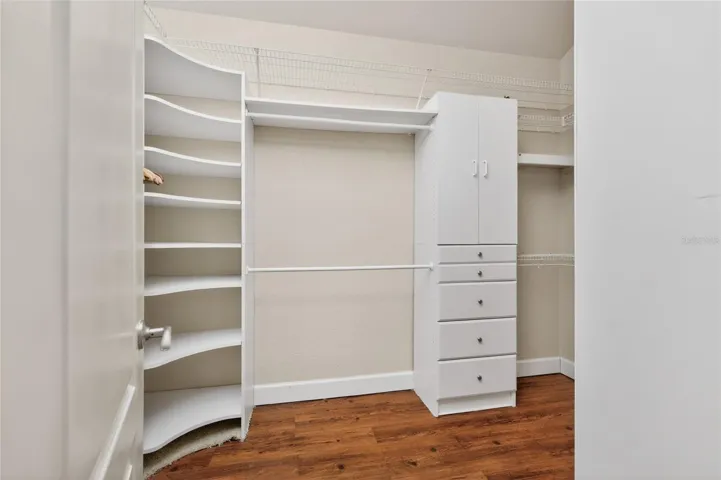 What a great walk in closet with all of these built ins!