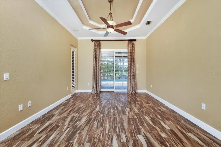 Primary bedroom has sliding glass doors opening on to the lanai