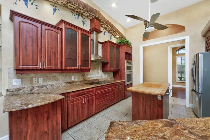 What pretty kitchen cabinetry, with crown moulding on top and decorative backsplash!