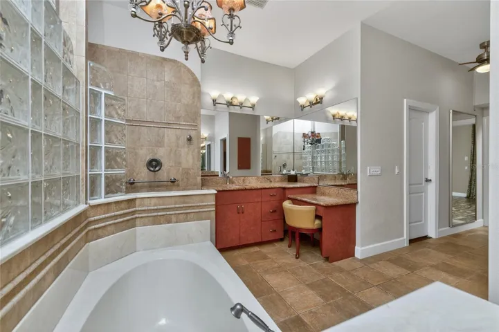 Glass block in between the bath area and the shower allows for plenty of light into the shower!