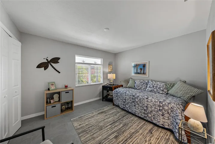 SECOND Bedroom- NEW Porcelain Tile Flooring, Fresh Paint and Hurricane Impact Window!