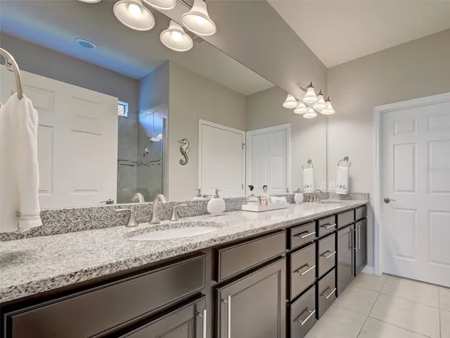 Long Primary bathroom with double sinks and loads of storage