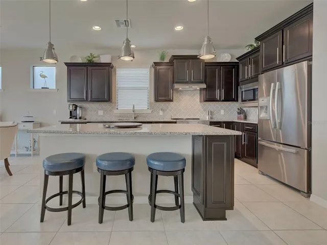 Kitchen with oversized bar, new stove and upgrading ligting