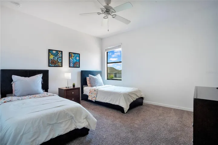 Bedroom with dual beds and bright natural light.
