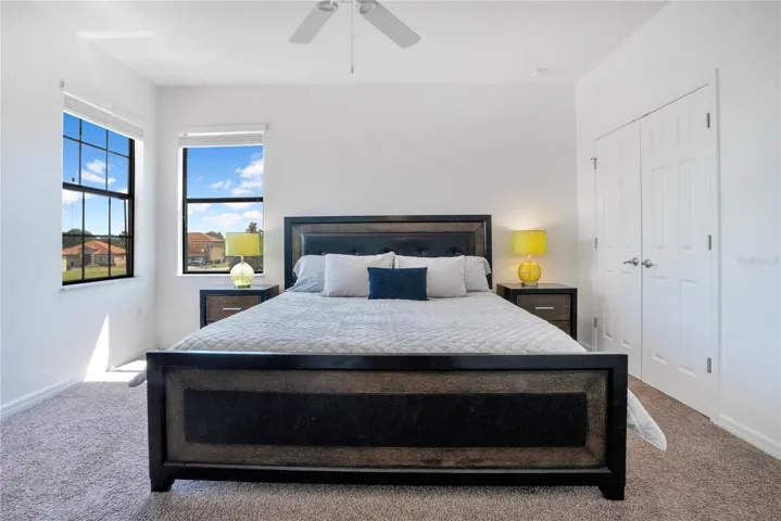 Spacious bedroom with large windows and privacy.