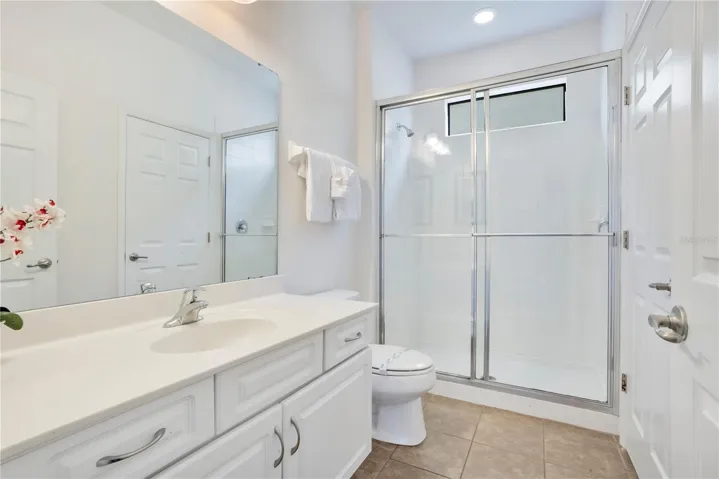 Primary bathroom with walk in shower and vanity space.