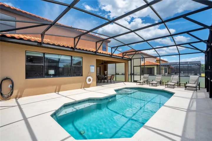 Screen enclosed private pool with spacious deck for outdoor living.