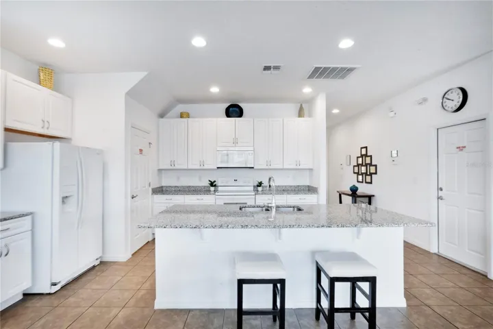 Kitchen with island seating and adjacent dining space.