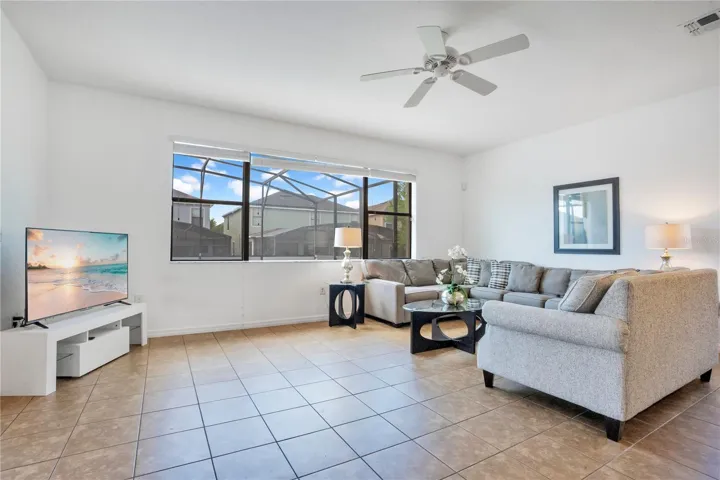 Open living room with tile floors and natural light throughout.