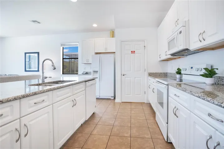 Spacious kitchen with breakfast bar and open sightlines.