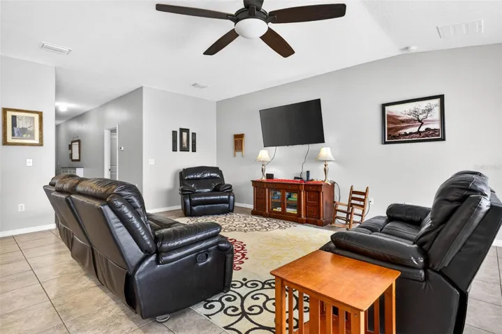 Living area with ceramic tile and ceiling fan