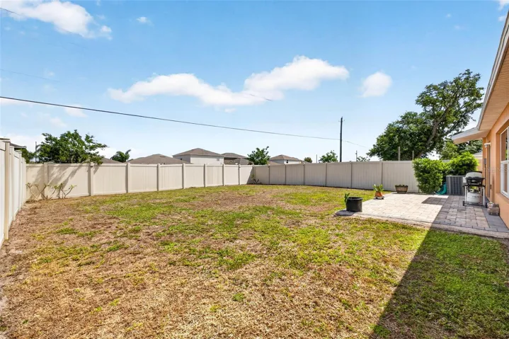 Fully fenced back yard with pavered patio for year round outdoor living.