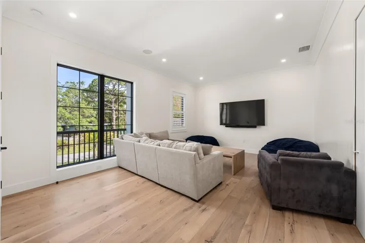 Spacious upstairs media room perfect for movie nights, relaxing, or a flexible family gathering space.