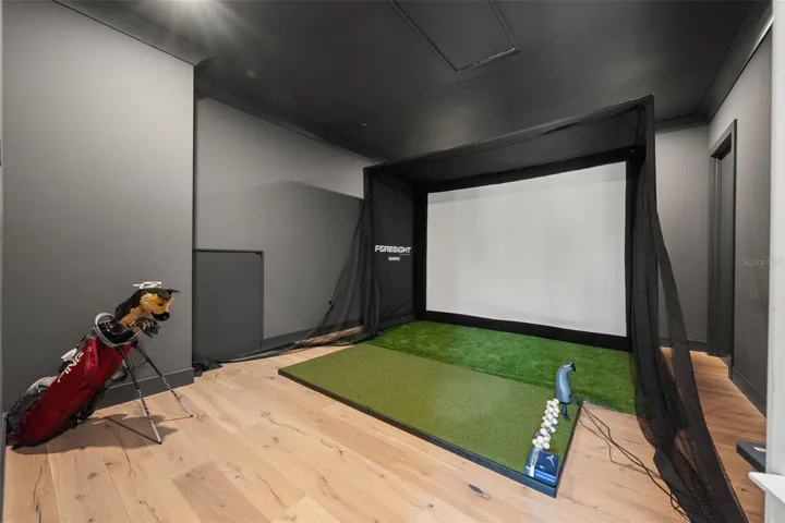 Dedicated golf simulator room featuring a Foresight golf simulator, creating the ultimate space for practicing your swing