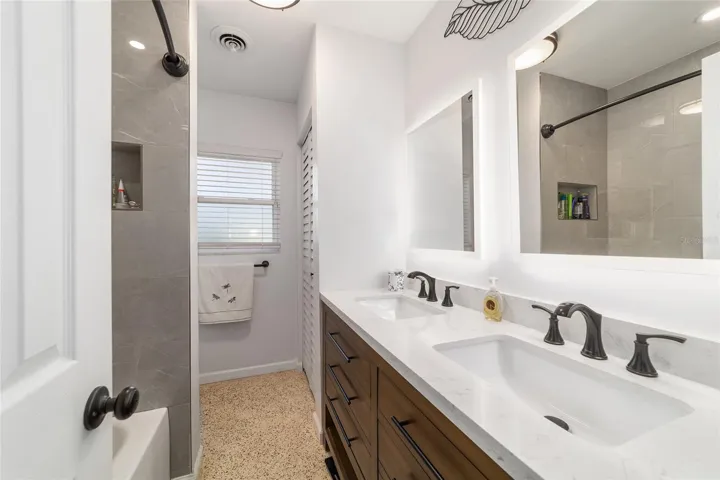Guest Bathroom with Double Sinks and Tub/Shower Combo