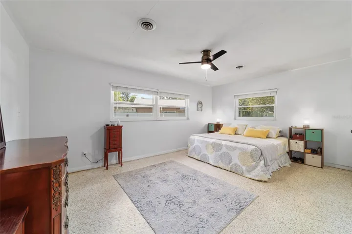 Primary Bedroom with Terrazo Floors and Walk-In Closet